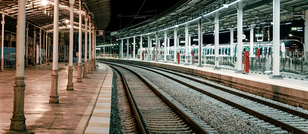A deserted station platform lit at night